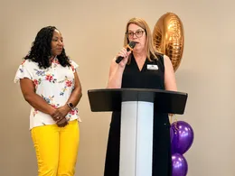 Two speakers at a Good Hands event podium