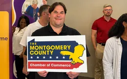 Guest holding a Montgomery County Chamber of Commerce sign